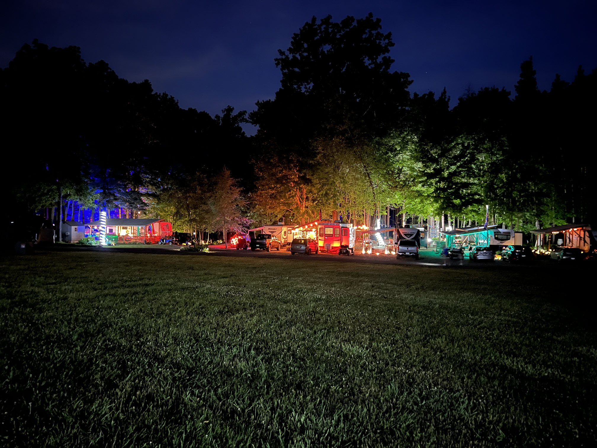 Row of seasonal camp sites lit up at night